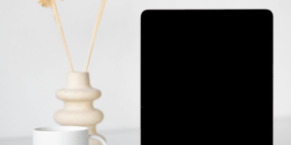 Desk with coffee and a tablet showing a newsletter signup