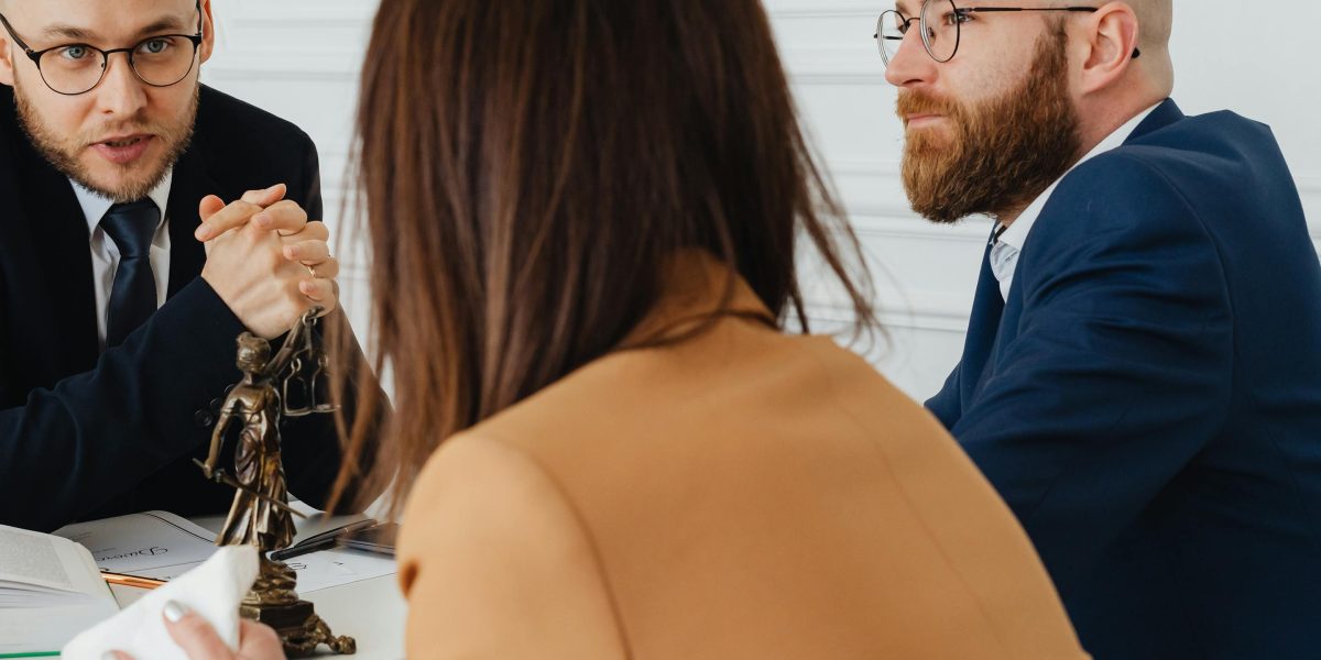 Legal professionals review documents and discuss the complexities surrounding copyright and ethics in AI-generated content.