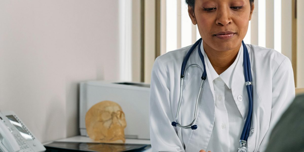 A medical professional offers comfort to a patient, addressing concerns about diagnostic imaging results.
