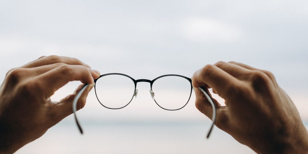 A professional looking thoughtfully, processing complex information to gain a clear strategic insight.