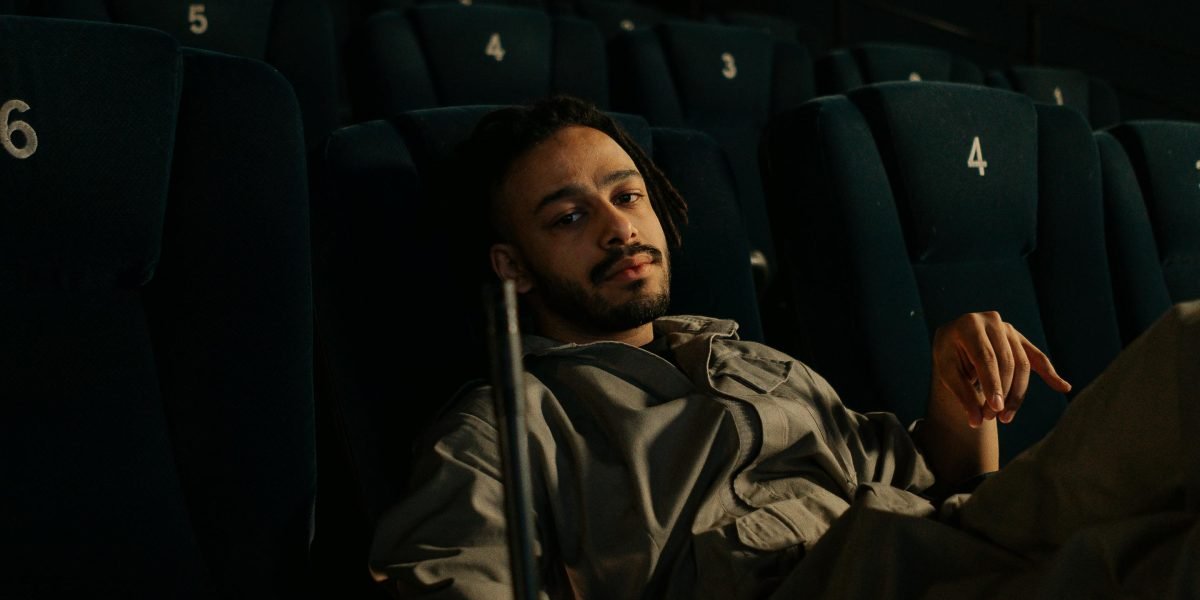 A person deeply engaged and relaxed while consuming personalized content on a streaming platform.