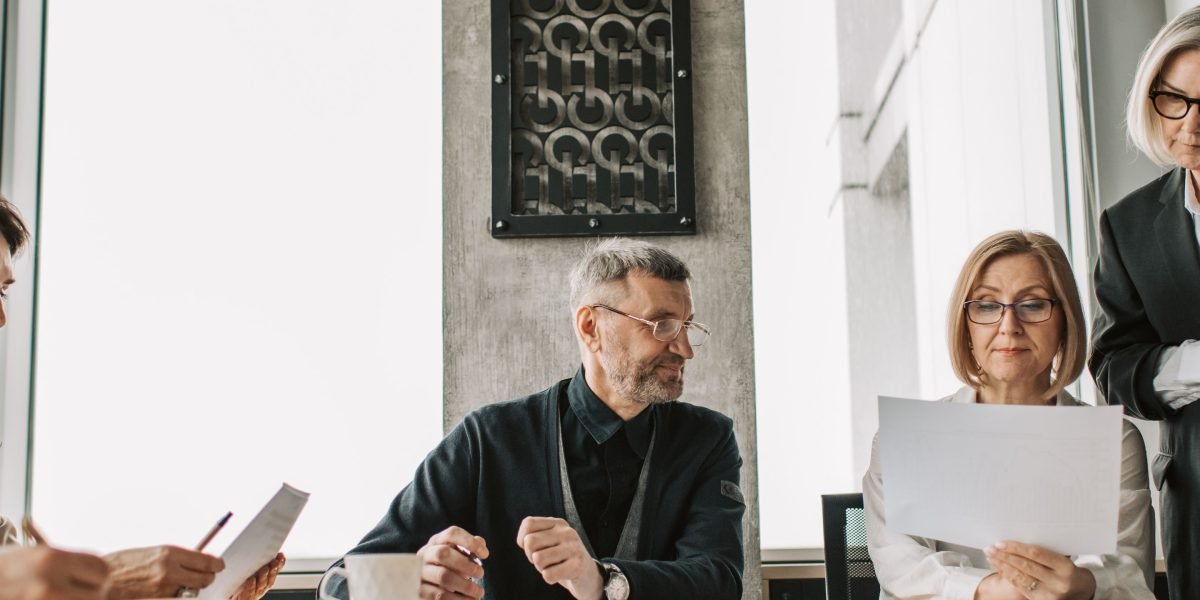An executive team collaborates, analyzing data and strategic plans for the future of AI.