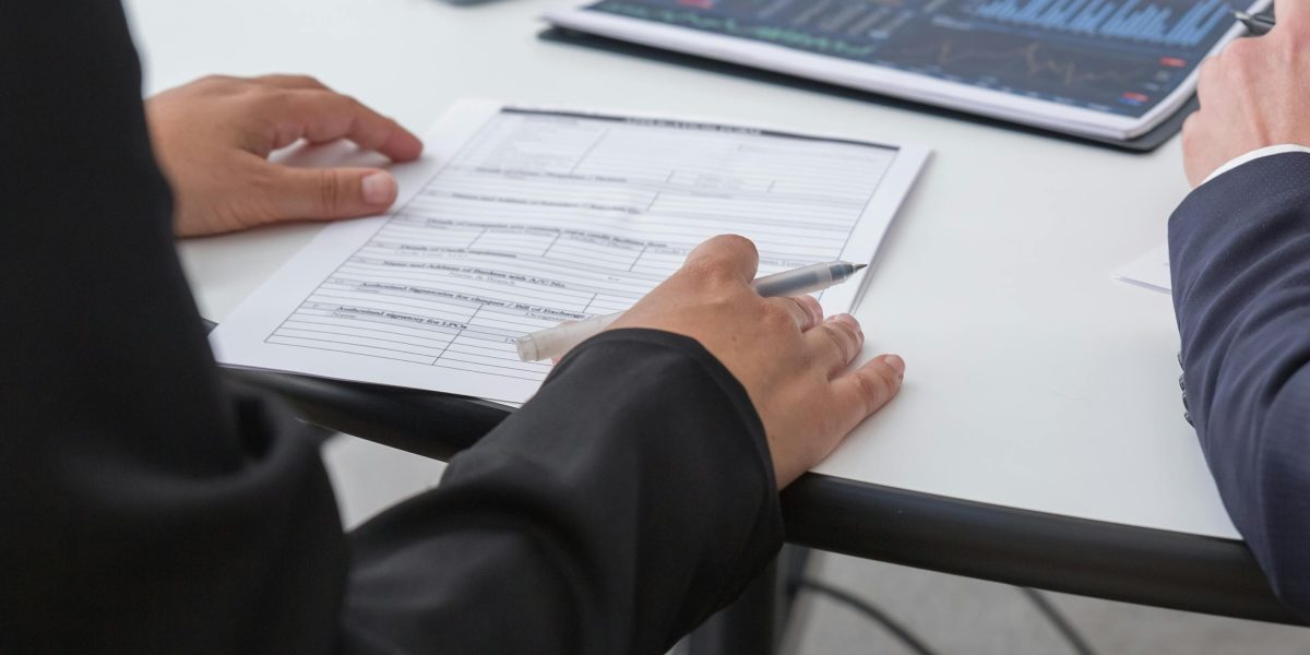 Business professionals reviewing data or a project, representing enterprise adoption and real-world application of AI.
