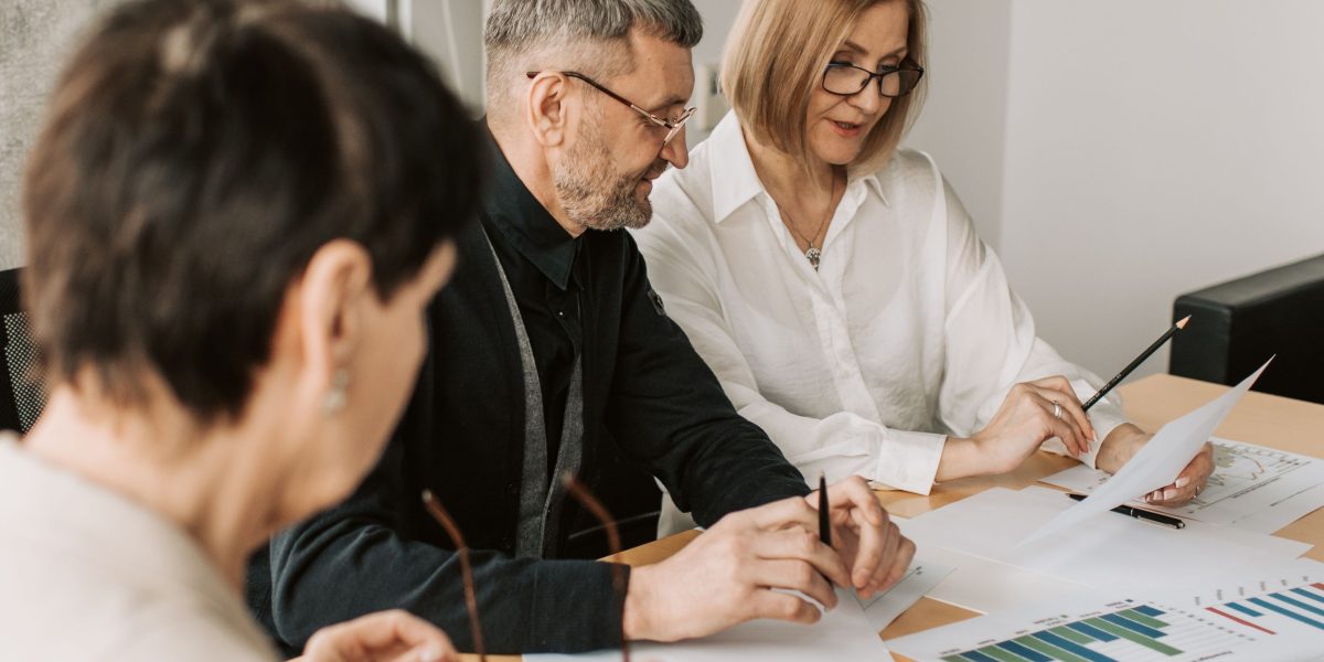 A team of professionals collaborating and strategizing in a meeting room, freed from repetitive tasks by AI assistance.