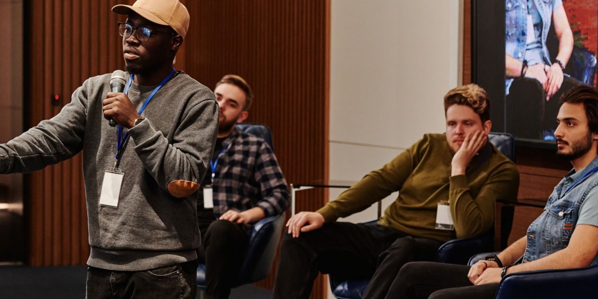 A confident presenter addressing a diverse audience, illustrating the skill of tailoring communication for different groups.