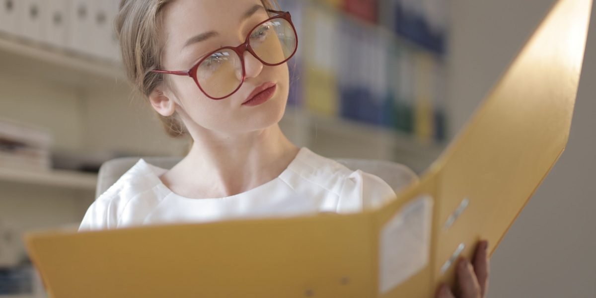 A person reviewing legal or financial documents in a professional setting, symbolizing careful due diligence and understanding of ownership structures.