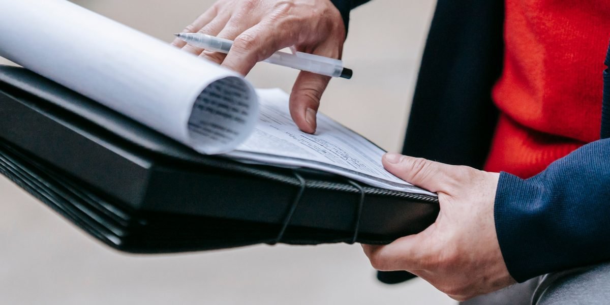A person intently reviewing documents, symbolizing the critical process of data preparation and quality assurance in machine learning.