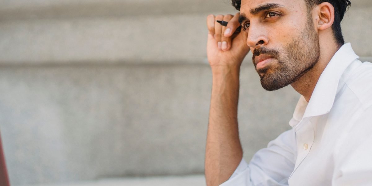 An individual in a professional setting contemplates a complex business challenge, symbolizing the need for clear distinctions.