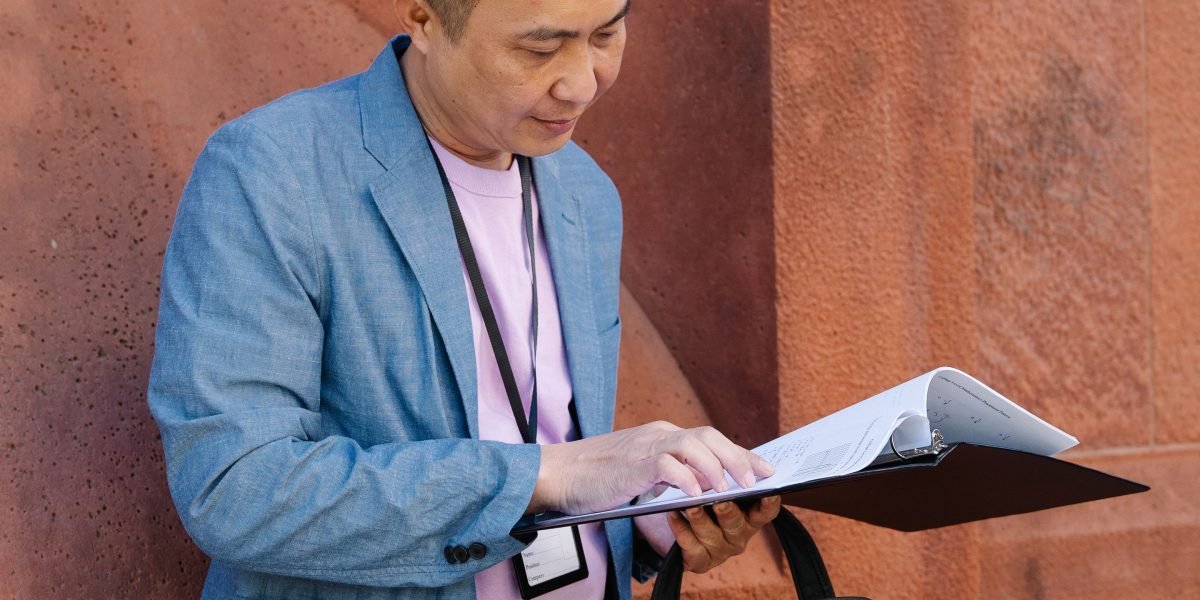 A person intently reading and taking notes, symbolizing the effort to stay updated in a rapidly evolving field.