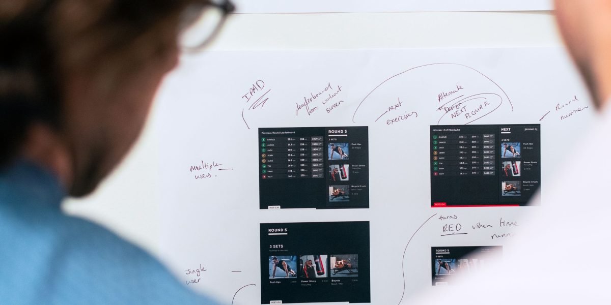 A team actively collaborating around a whiteboard, representing strategic planning and understanding market categories.