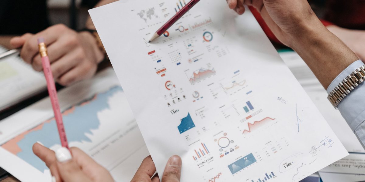 A team actively collaborating, using a whiteboard to outline a strategic plan for evaluating and adopting new technologies like blockchain.