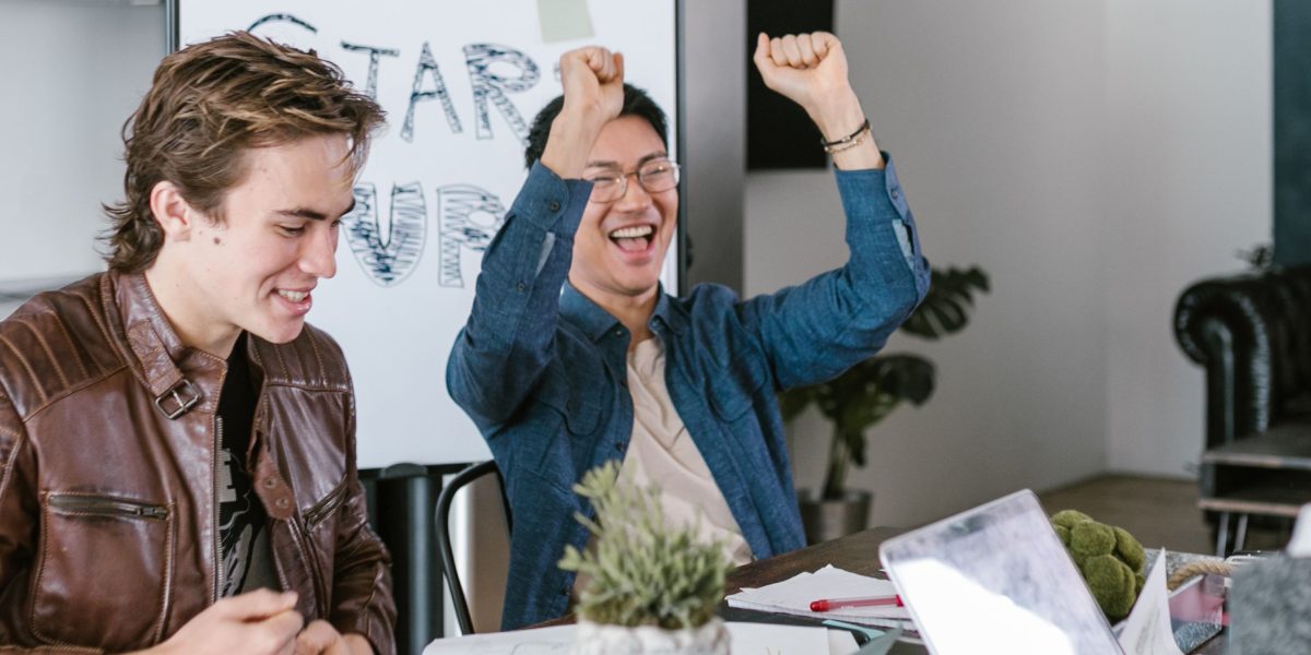 A business team celebrating a milestone or project completion, reflecting success in a competitive market.