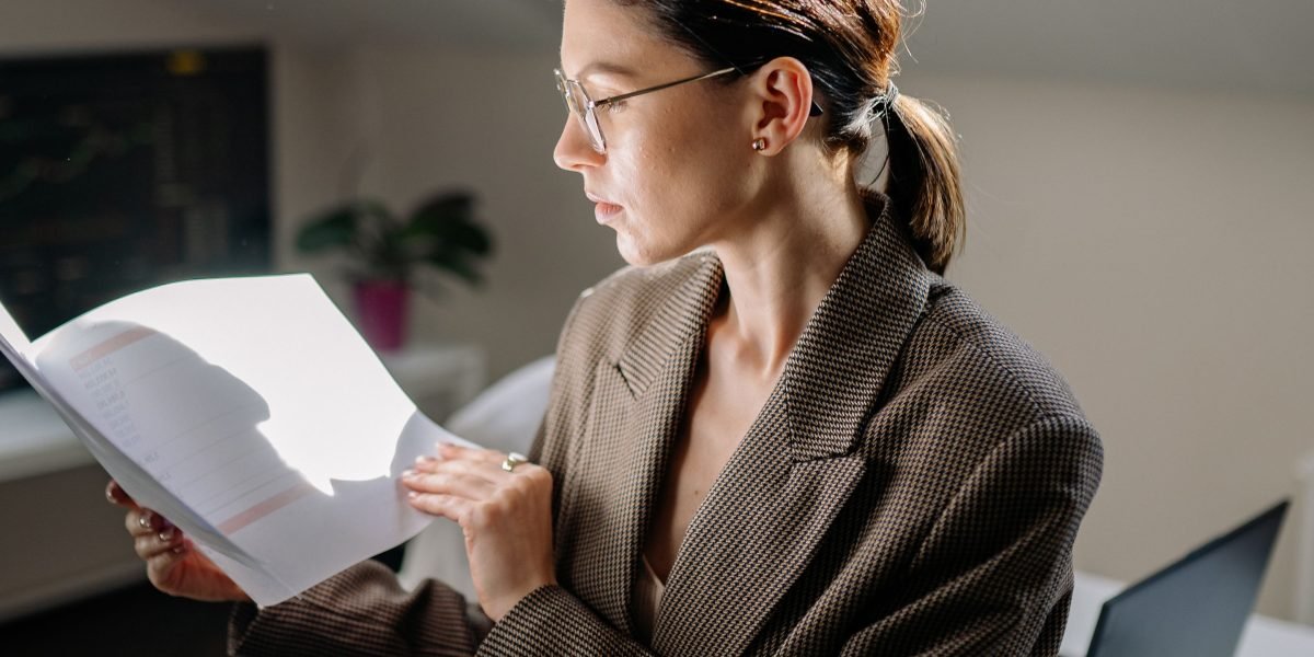 A visual representation of a person carefully assessing documents and information.