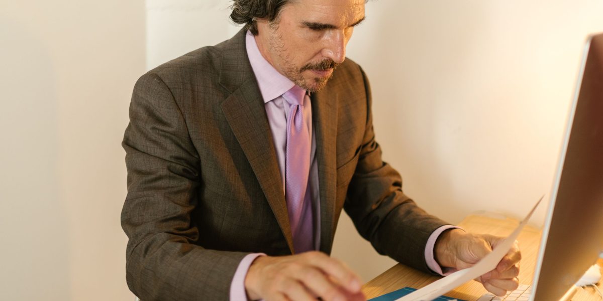 A professional diligently reviewing financial documents to assess a company's performance and future outlook.