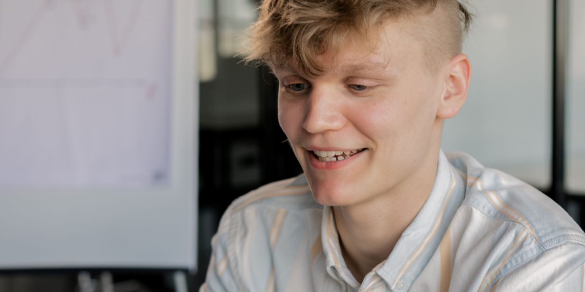 A person with a thoughtful expression, representing the concept of innovation and bringing intelligence to small-scale applications.