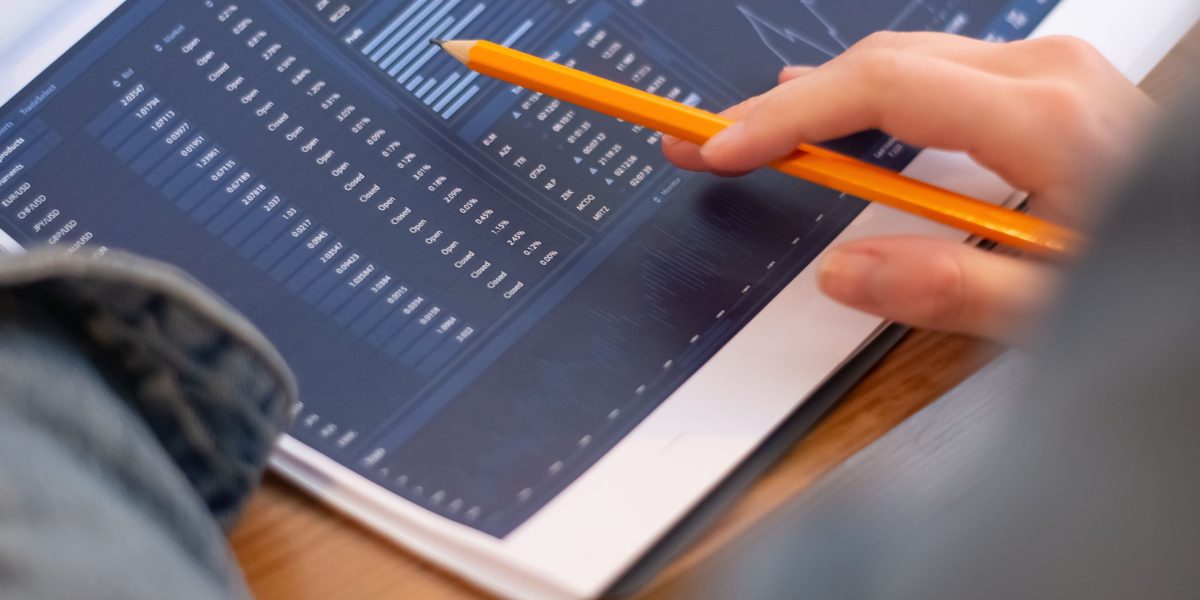 A person thoughtfully reviewing documents, symbolizing the challenge of sifting through vast amounts of information.