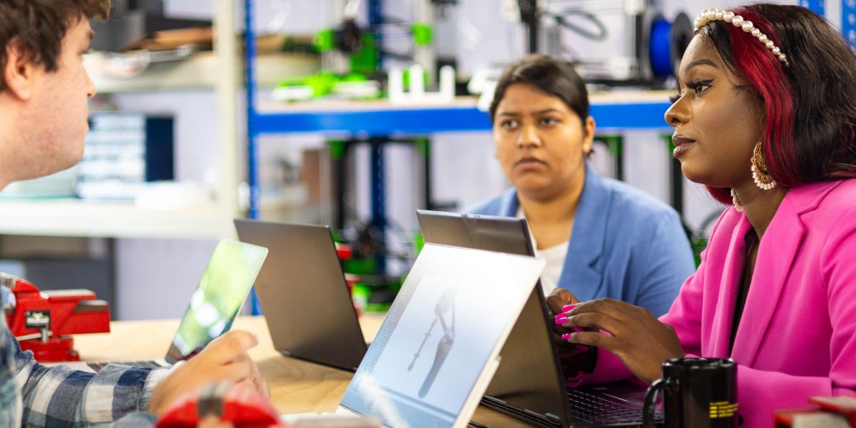 A team actively collaborating, demonstrating how understanding scientific principles leads to better technology solutions.