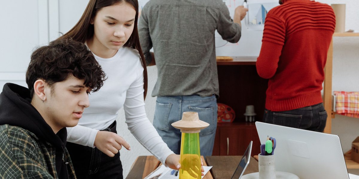 A group of professionals examining and discussing a physical prototype, illustrating the product development phase.