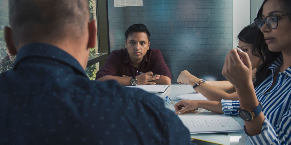 A group of professionals engaged in a serious discussion about cybersecurity, addressing potential quantum threats and solutions.