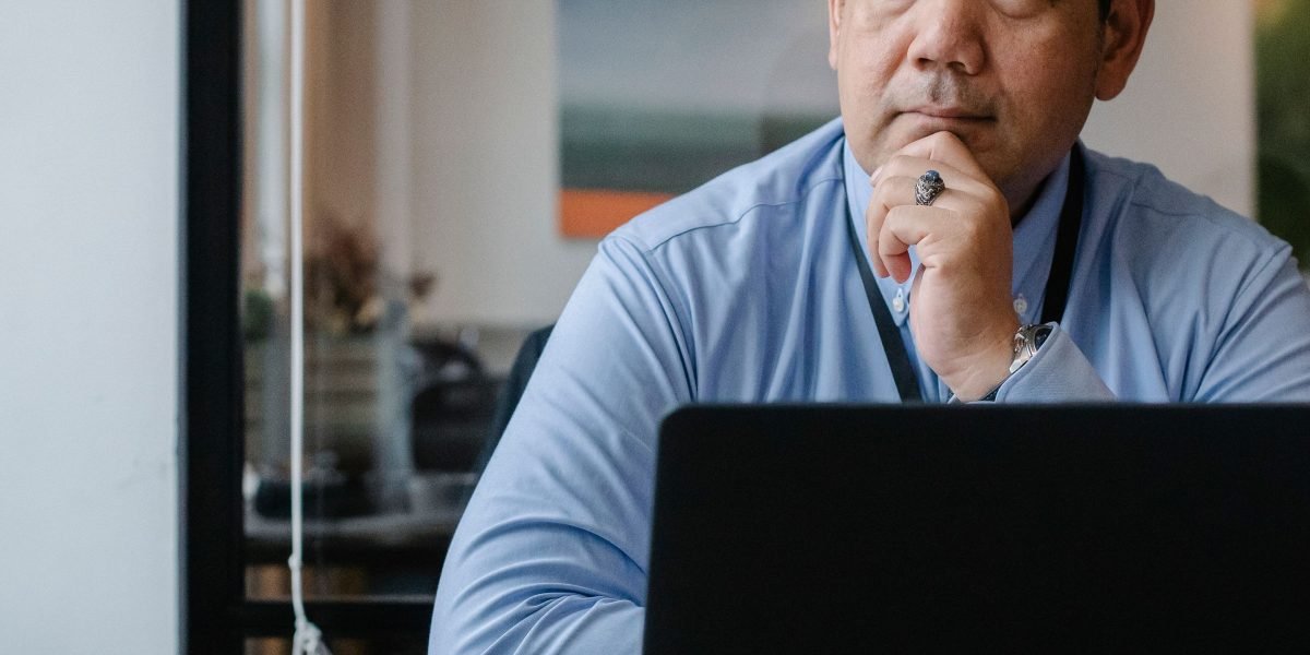 A thoughtful business leader contemplating strategic decisions related to adopting new technologies.