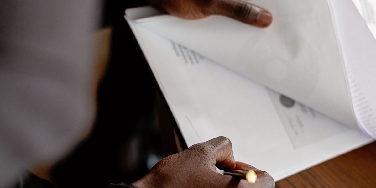 Professionals carefully review government contracts and regulatory documents for compliance.