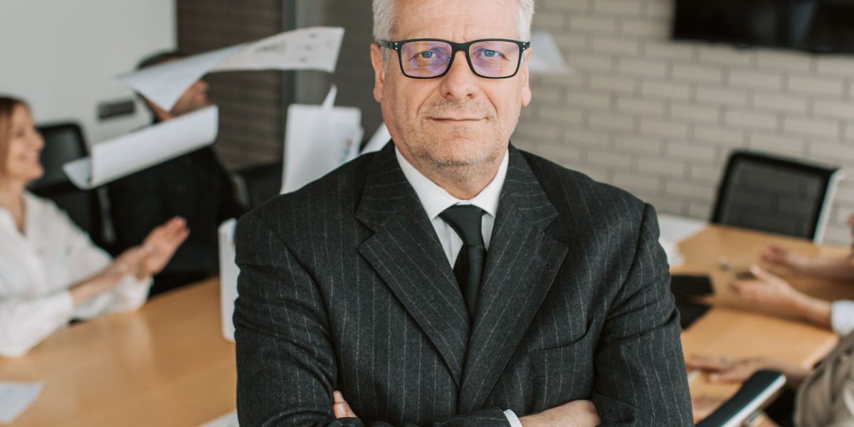 A business leader deep in thought, considering the vast opportunities and challenges presented by rapidly evolving AI technologies.