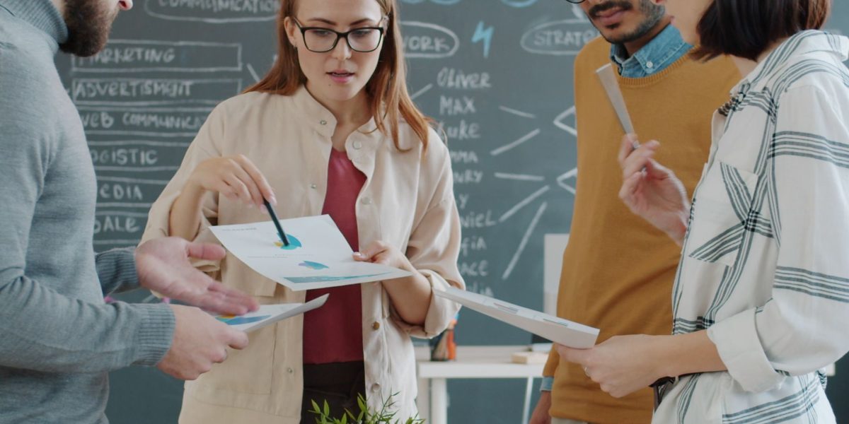 A diverse team collaborating around a whiteboard, mapping out strategies and aligning AI capabilities with business objectives.