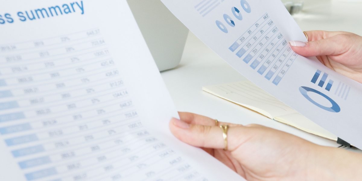 A professional analyzing reports and data, signifying the critical importance of measuring AI's impact on business outcomes.