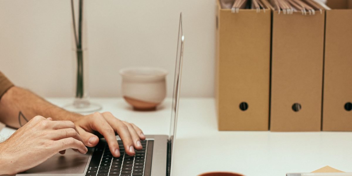 A person diligently organizing their tasks and information flow at a desk, representing an efficient workflow.