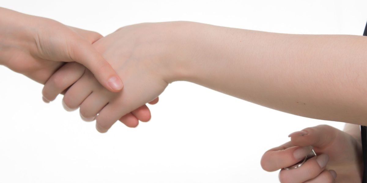 Two business professionals shaking hands, symbolizing a successful partnership agreement and collaboration.