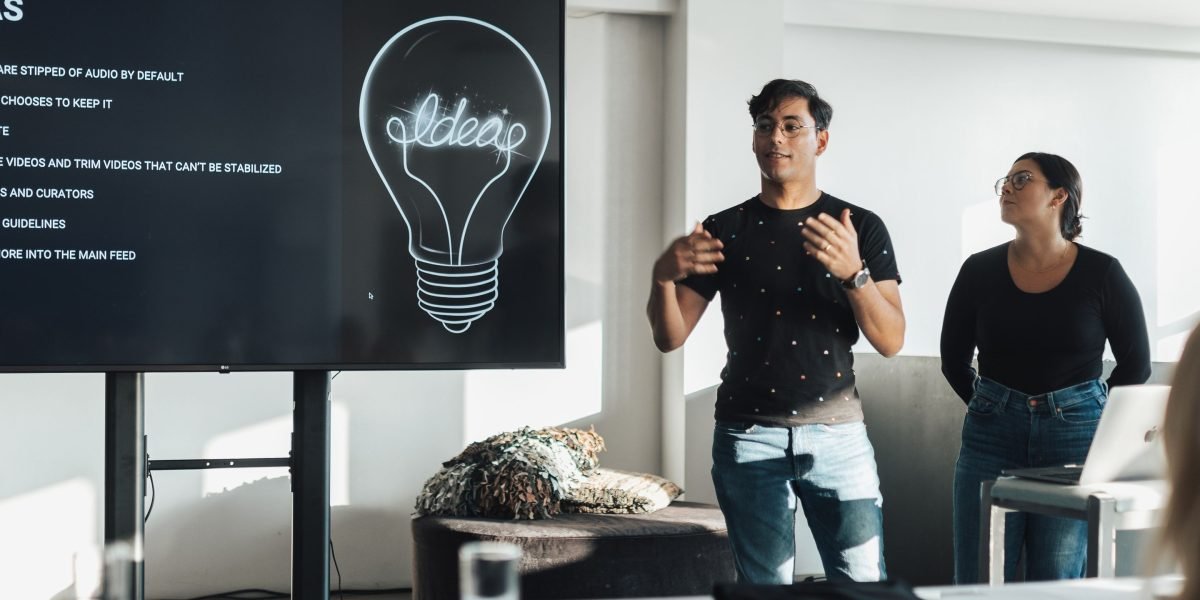 A person confidently presenting an idea, embodying the success of securing support for a project.